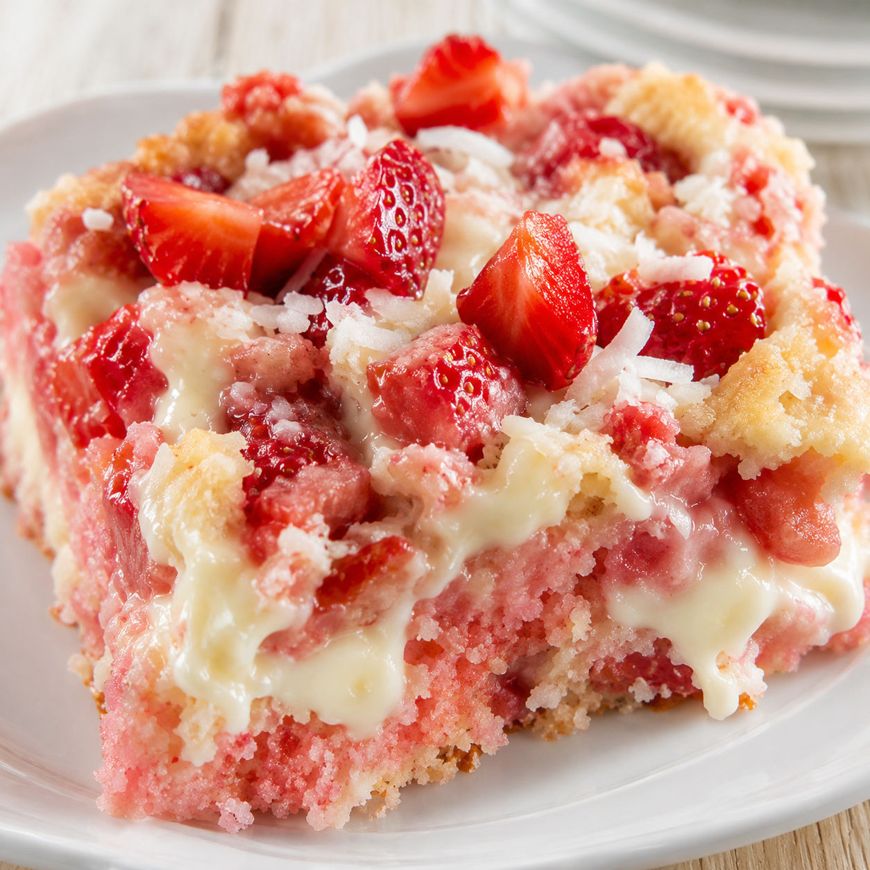 Strawberry earthquake cake with cream cheese swirls and fresh berries