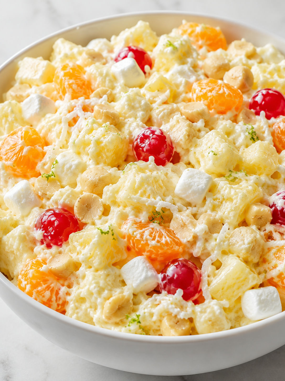 Creamy Tropical Pineapple Fluff with cherries, coconut, and macadamia nuts