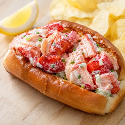 Ultimate lobster roll in a toasted split-top bun with chives and lemon