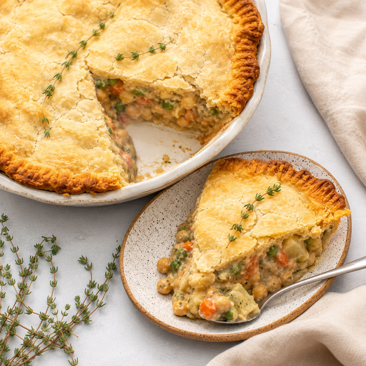 Vegan chickpea pot pie with golden crust and creamy vegetable filling
