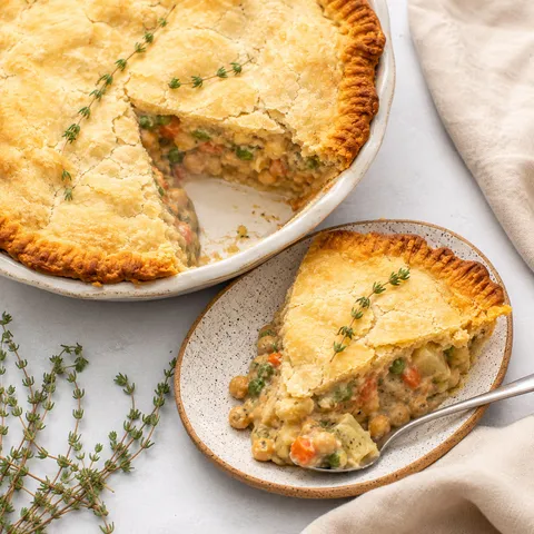 Vegan chickpea pot pie with golden crust and creamy vegetable filling
