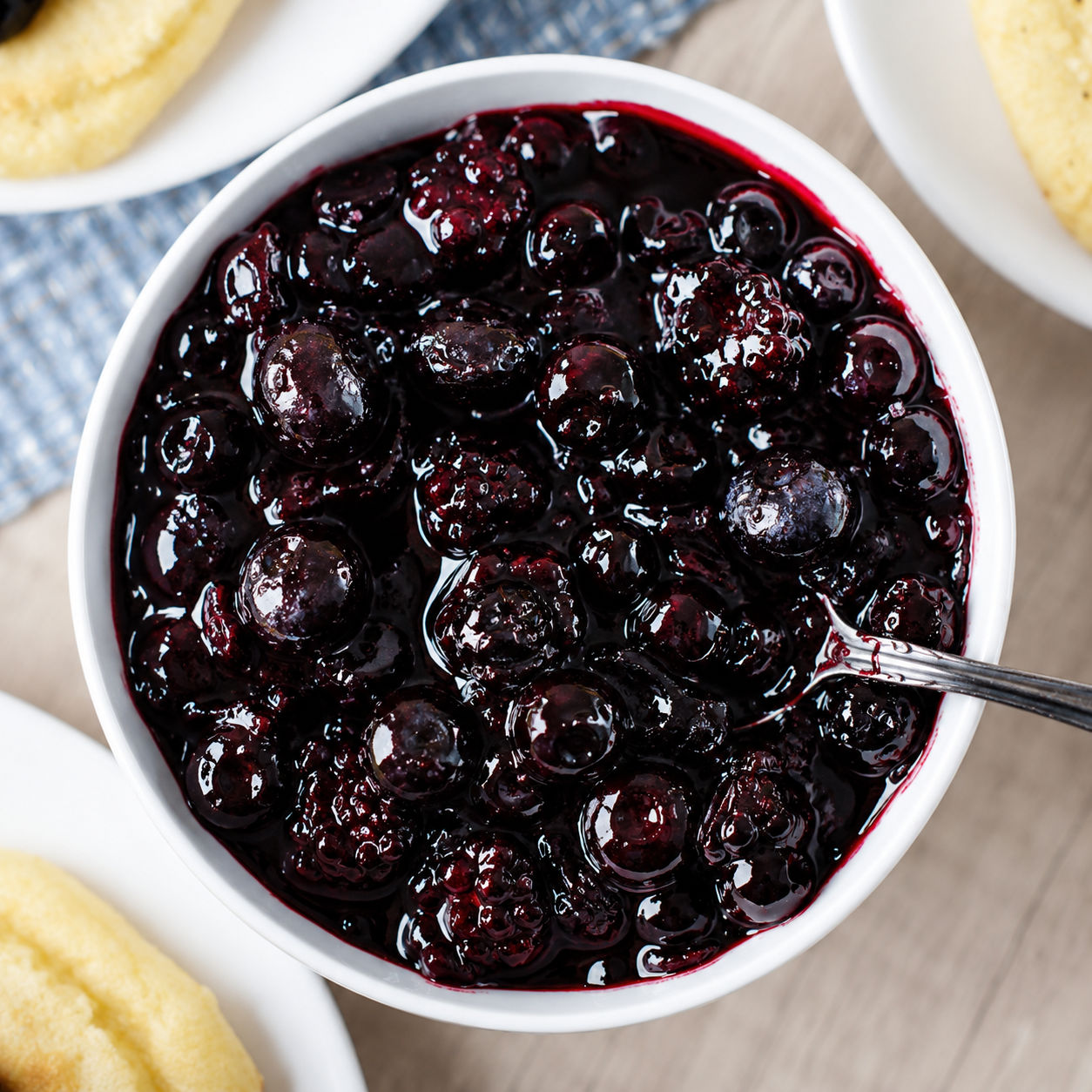 Wojapi berry sauce in a white bowl with fry bread nearby
