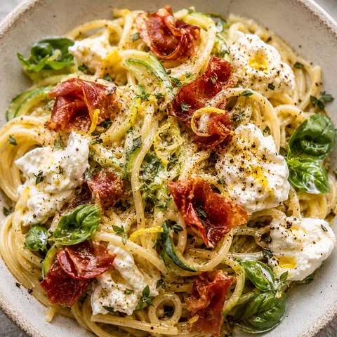 Zucchini carbonara with crispy prosciutto, burrata, basil, and lemon zest