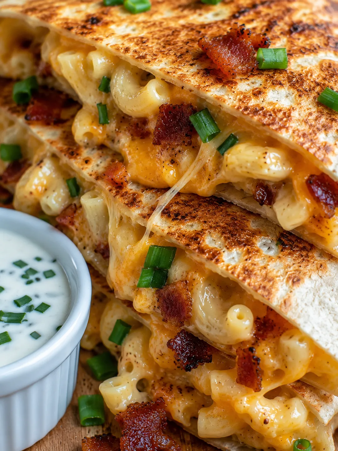 Crispy bacon ranch mac and cheese quesadilla wedges with melted cheese