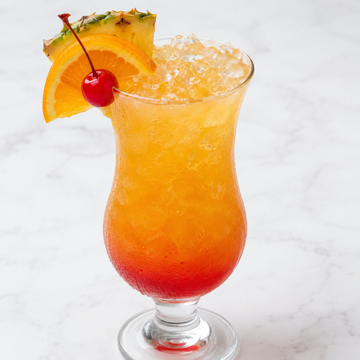Bahama Mama tropical drink with pineapple, orange, and cherry garnish