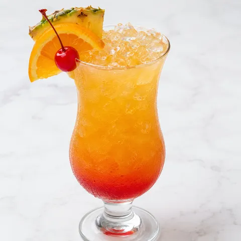 Bahama Mama tropical drink with pineapple, orange, and cherry garnish