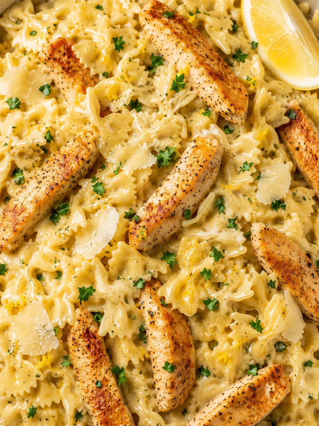 Creamy bowtie lemon garlic chicken pasta with chicken, parsley, and Parmesan