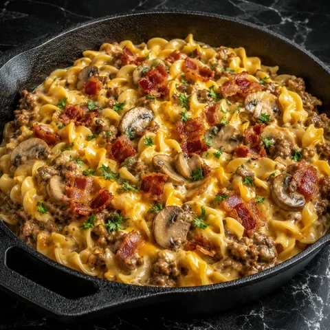 Cheesy beef noodle skillet with bacon, mushrooms, cheddar, and parsley