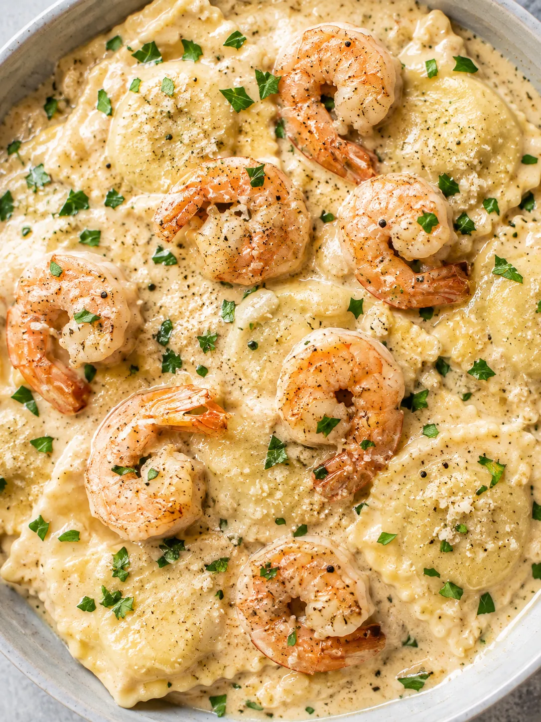 Creamy shrimp Parmesan ravioli with glossy sauce and parsley