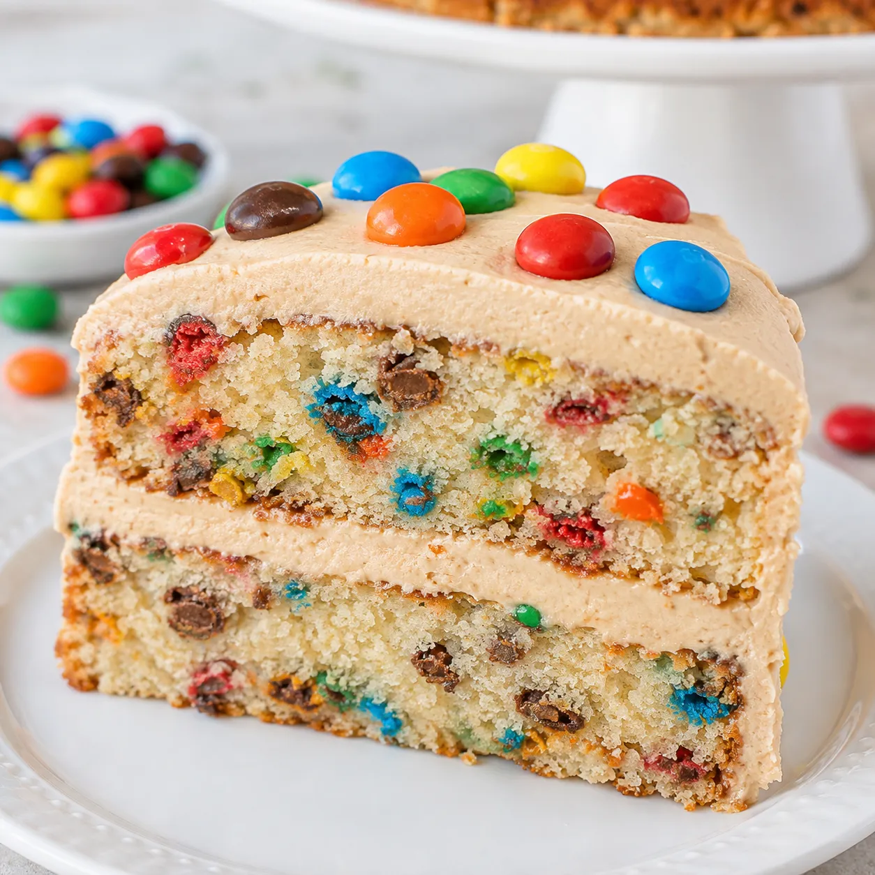 Peanut Butter M&M's Cake with frosting and colorful candy on top