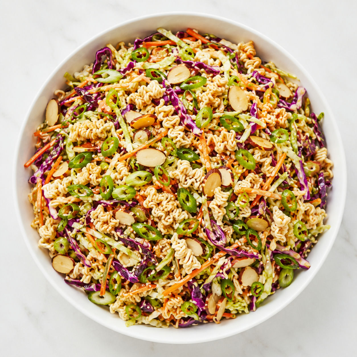 Ramen noodle salad with cabbage, carrots, almonds, and scallions