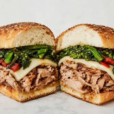 Roast pork sandwich with provolone, broccoli rabe, and pork jus