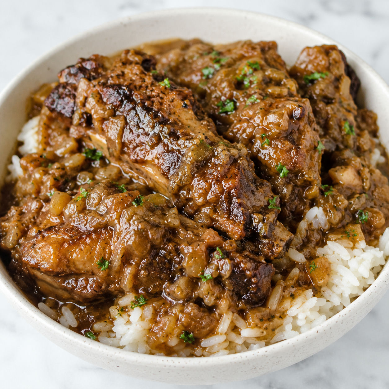 Smothered turkey wings with brown gravy over white rice