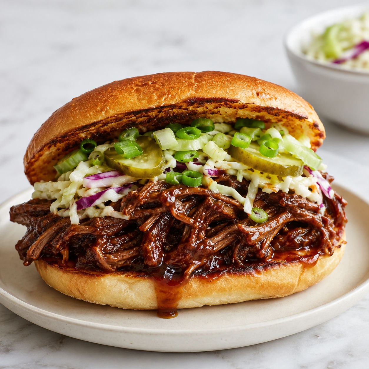 Spicy ginger ale shredded beef sandwich with slaw and pickles