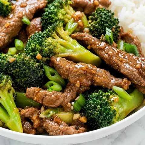 Steak and broccoli stir-fry with glossy sauce and green onions