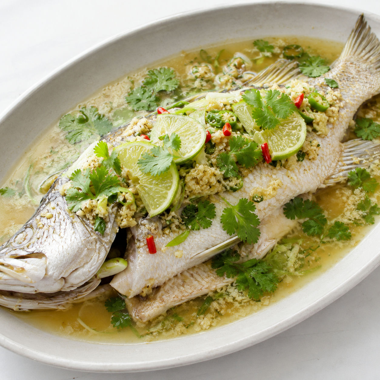 Thai lime-garlic steamed whole fish with chilies, cilantro, and lime