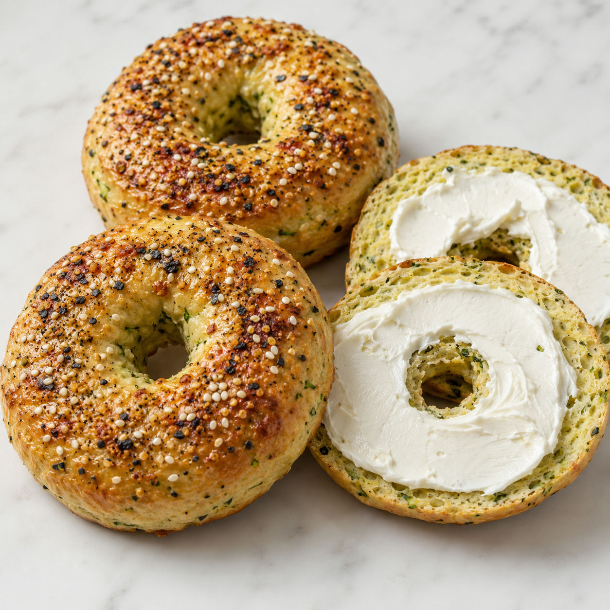 Golden keto zucchini bagels with everything seasoning and cream cheese