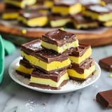 A plate of chocolate and yellow desserts.