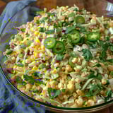 A bowl of food with corn and jalapenos.
