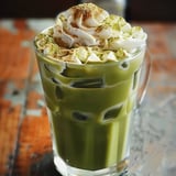 A glass of green tea with whipped cream.