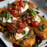A plate of food with tomatoes and cheese.