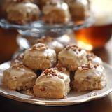 A plate of cake with nuts on top.