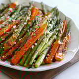 A white plate with a bowl of vegetables.