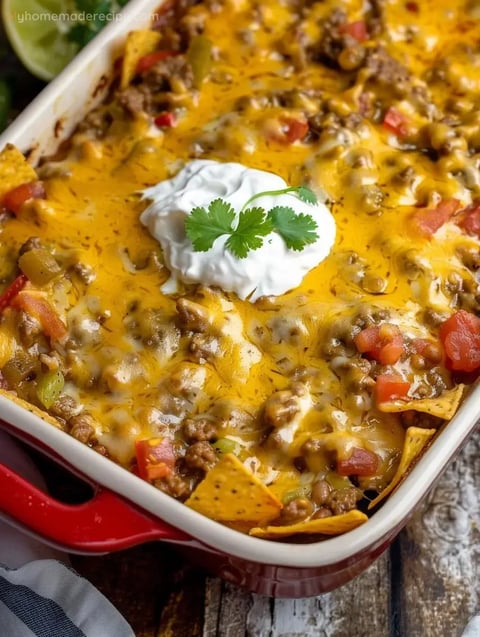 A baked Mexican White Trash Casserole with melted cheese and tortilla chips