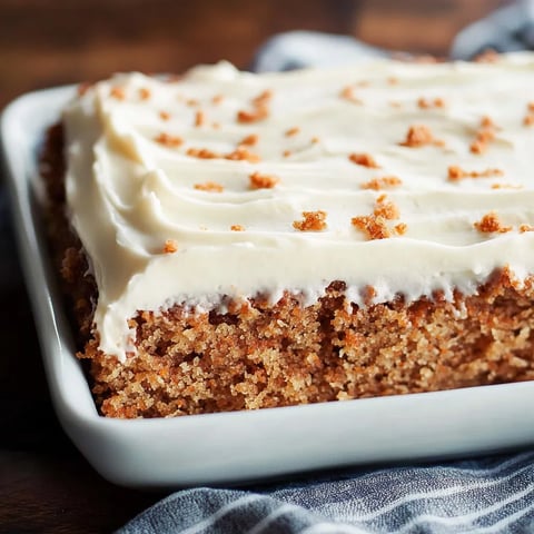 A slice of cake with white frosting.
