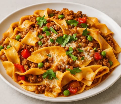 A plate of pasta with meat and vegetables.