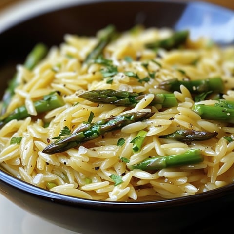 A bowl of garlic butter asparagus orzo.