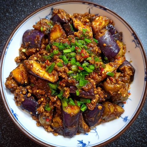 A bowl of Spicy Sichuan Eggplant filled with various ingredients.