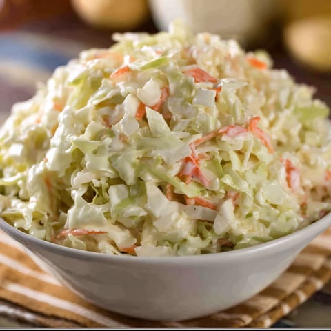 A large bowl filled with a delicious coleslaw recipe.
