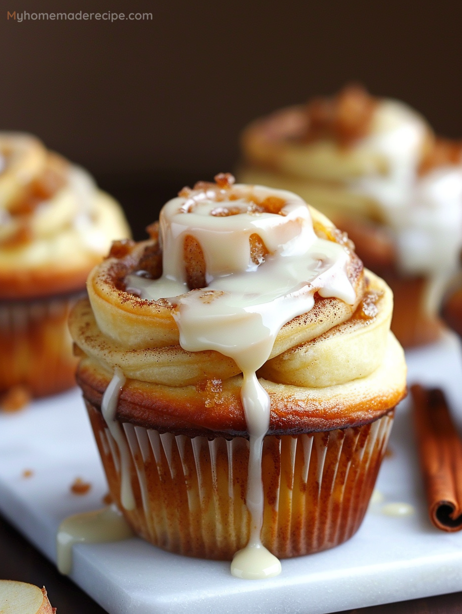 Delicious Apple Cinnamon Roll Cupcakes drizzled with glaze.