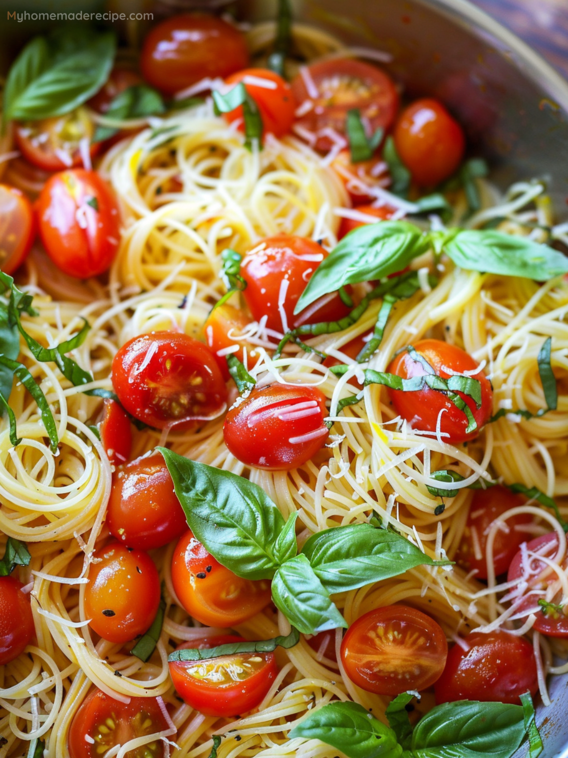 A vibrant bowl of Summer Garden Pasta with cherry tomatoes, basil, and Parmesan cheese